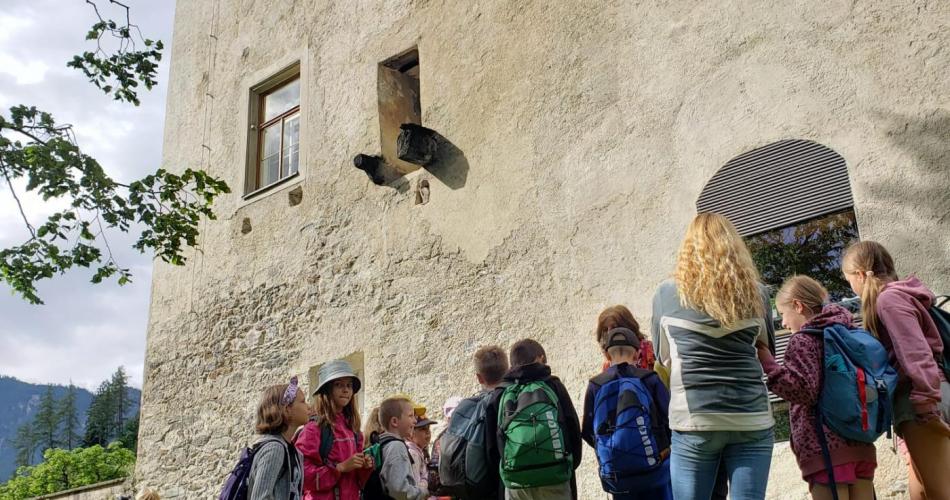 Gruppe von Kindern vor Schlossmauer